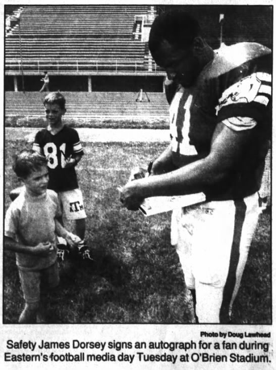 Safety James Dorsey signs an autograph